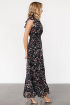 Back view showing the smocked high neckline with button closures and the gentle drape of the chiffon fabric.