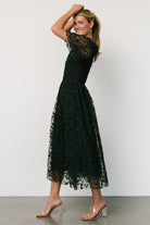 Back view of Kendra midi dress showing single-button keyhole closure, smocked back detail, and smooth, fully lined interior.