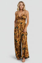 Back view of the Khloe jumpsuit showing the smocked back and how the palazzo legs drape for a relaxed yet refined silhouette.