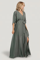 Close-up of surplice neckline and kimono sleeve detail on dark sage Kia maxi dress, showing fabric drape and finish.