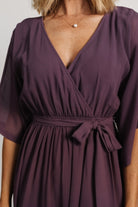 Three-quarter view of the Kia Kimono Maxi Dress in vintage plum, highlighting the elastic waist, detached self-tie sash, and overall flowy maxi silhouette.