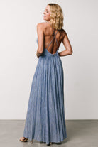 Three-quarter view of Korley Maxi Dress in blue stripe showing silhouette, adjustable straps and full skirt movement on model.