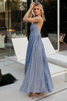 Back view of Korley Maxi Dress in blue stripe highlighting open crossover back, hidden zipper and flowing lined maxi skirt.