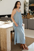 Side view of Kyla Maxi Dress in medium denim wash on model, highlighting the straight fit, unlined skirt and natural drape.