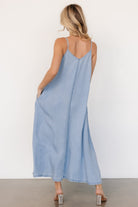 Kyla Maxi Dress styled with sandals and tote, showing full-length maxi hem, hidden pockets, and relaxed straight fit.