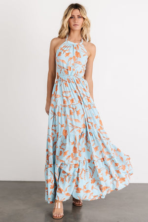 Styled outfit photo with the blue and orange floral maxi dress paired with casual sandals, emphasizing versatility for daytime wear.