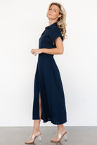 Styled outfit image of the navy Larah Button Dress paired with low heels, showing overall fit, length, and relaxed silhouette.