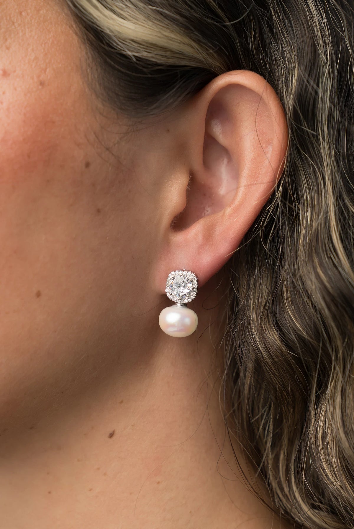 Laurent Pearl Halo Stud Earrings in Silver with cubic zirconia halo and faux pearl drop.