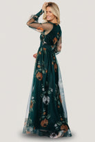 Back and side view of deep Topaz floral tulle maxi dress showing flow of skirt and sheer long sleeves with smocked cuffs.