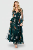 Long tulle maxi dress in deep Topaz green floral print with V-neckline, smocked waist, long sheer sleeves and flowing skirt.
