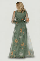 Full-length view of Layla Tulle Maxi Dress dusty olive floral, model wearing dress to show length, raw hem and soft drape of the skirt.