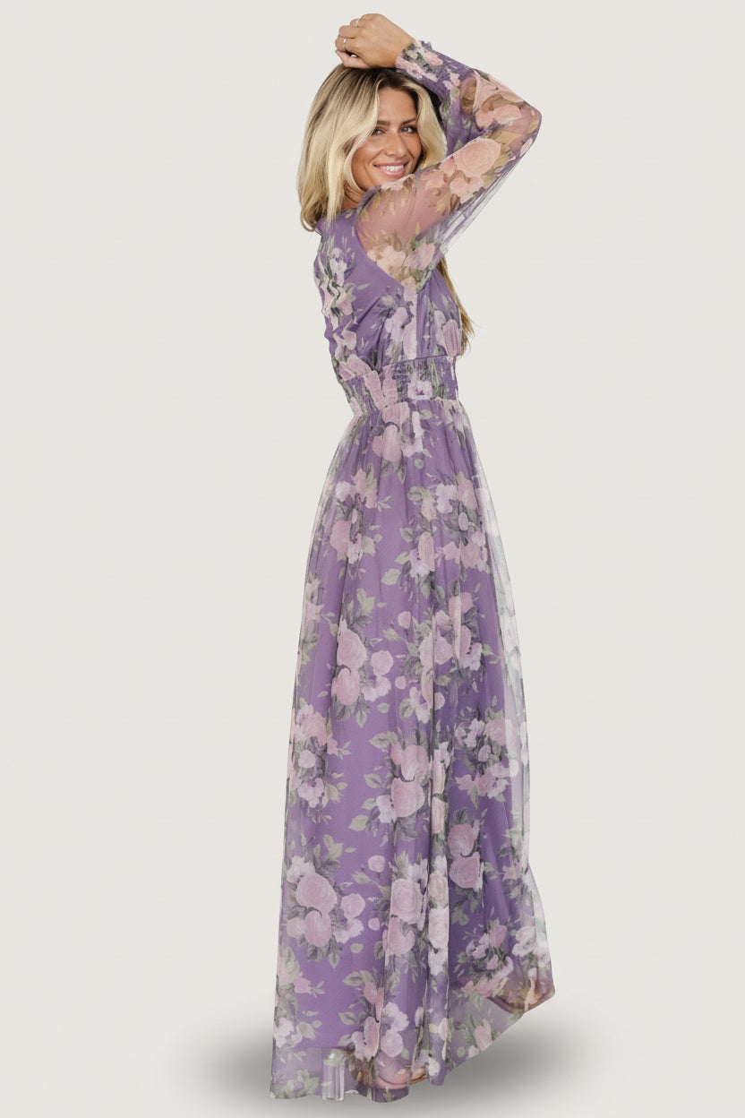 Styled shot of Layla Tulle Maxi Dress paired with heels, showcasing its floor-grazing tulle skirt, deep V-neckline, and romantic floral print.