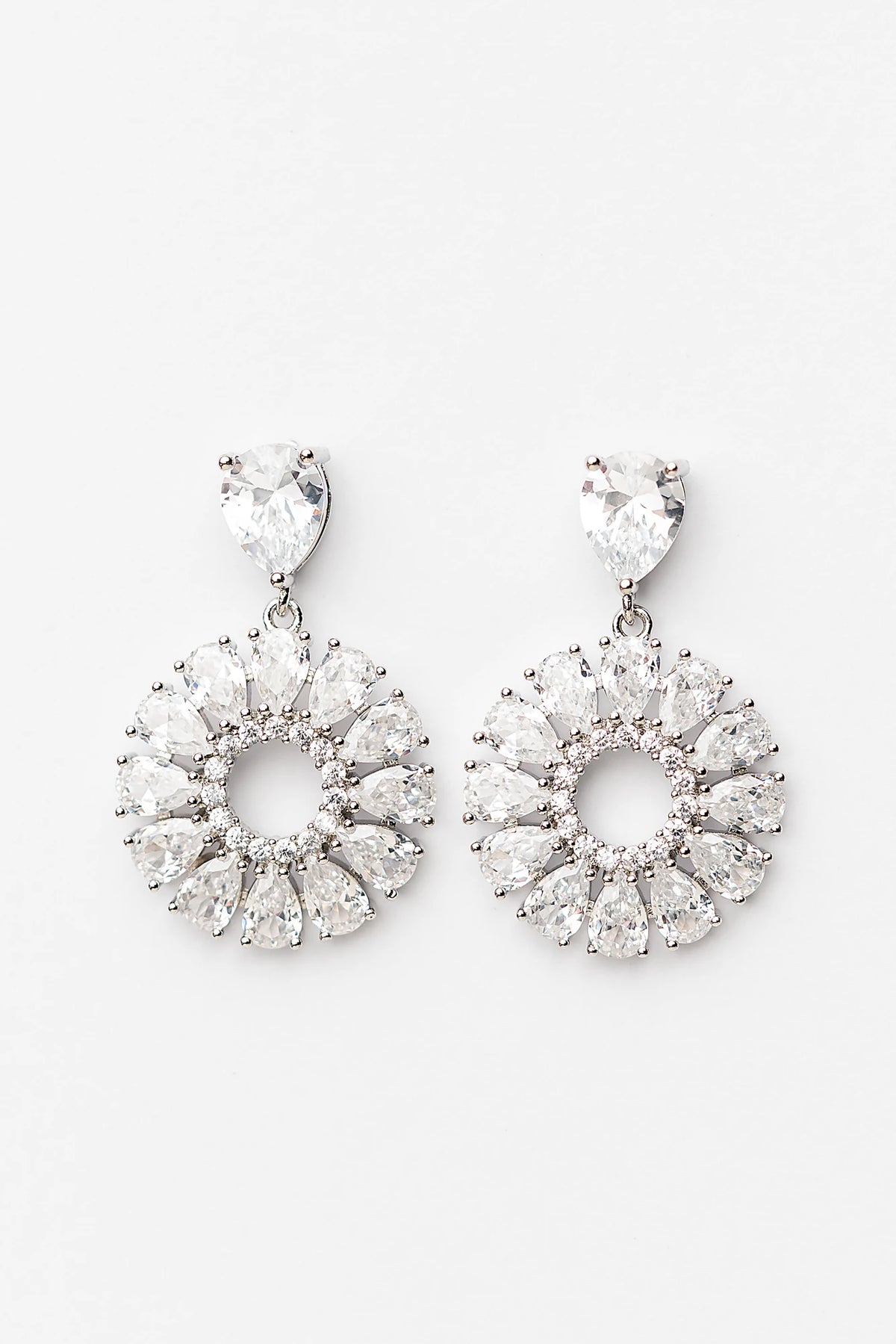 Lisandra Cluster Drop Earrings in Silver with teardrop studs, clear faceted stones, and circular cluster drops.