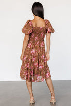 Back view of Lizzy smocked midi dress in floral chiffon, showing smocked back detail and tiered skirt silhouette.