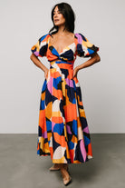 Full-length studio image of the Lola midi dress in rust and navy multi showing skirt length and overall silhouette.