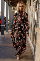 Front view of Luciana maxi dress in black and mauve floral chiffon with smocked neckline and single-tier flowing skirt.