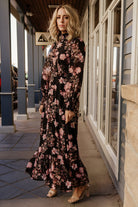 Detail shot of pleated front waist and elastic back, showing the fabric texture and tiered seam of the maxi skirt.