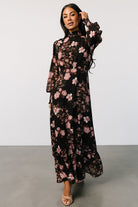 Side profile of Luciana maxi dress showing long smocked ruffle sleeves and gentle pleating at the front waist for movement.