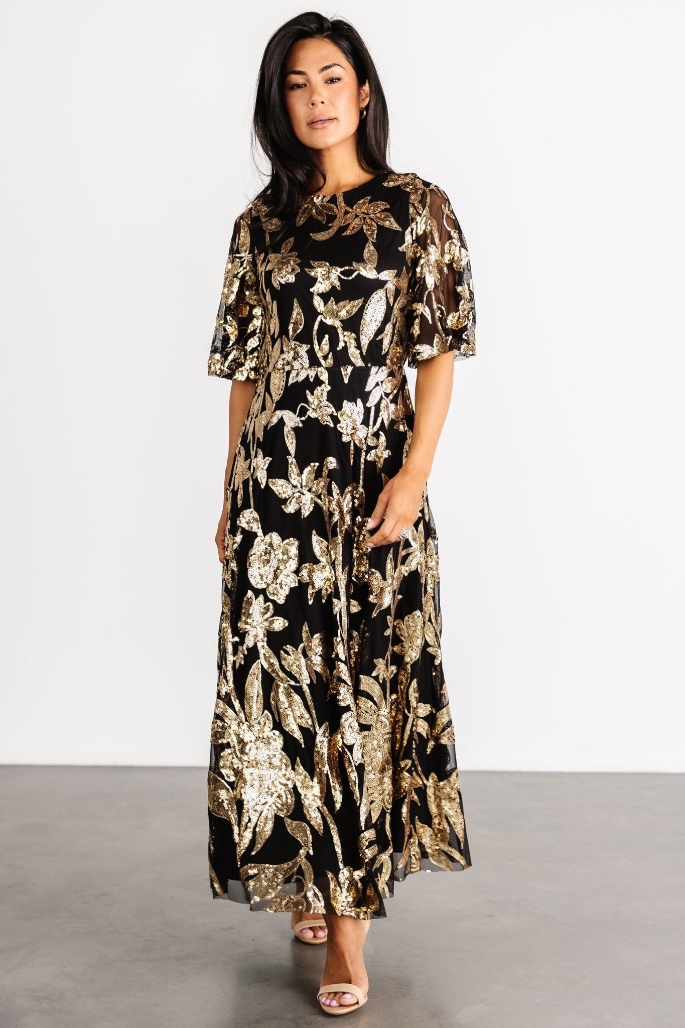 Detail of short tulle sleeve with raw hem and sheer appearance; sleeve is unlined to show delicate tulle texture.