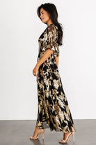Back view showing the keyhole-and-button closure and gentle gathering at the elastic waistband on the Lucy Sequin Dress.