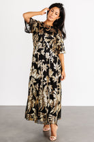 Full-length shot of the Lucy Sequin Dress illustrating the flowing silhouette, raw-hem skirt, and elegant movement when walking.