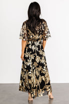 Close-up detail of gold sequin floral embroidery on black tulle overlay, showing texture and delicate sequin placement.