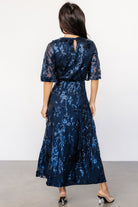 Full-length on-model image of the navy sequin maxi dress showing silhouette, skirt movement, and proportion for styling reference.