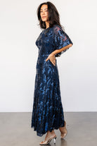 Back view highlighting the keyhole-and-button closure, elasticated waist, and the way the tulle drapes over the lined skirt.