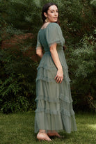 Full-length image of the Magdalena Tulle Maxi Dress in eucalyptus on model, showing silhouette and ruffle tiers for occasion wear.