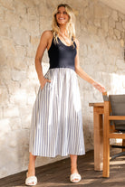 Full-length view of Marbella Tank Midi Dress in navy stripe demonstrating its midi length, lined skirt, and relaxed silhouette.