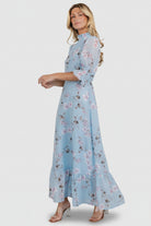 Model wearing Marie Mock Neck Maxi Dress in sky-blue floral chiffon, showing overall length, sleeve fit, and how the skirt moves while walking.