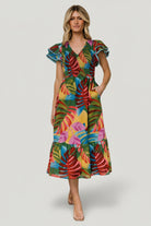 Three-quarter view of Marielle smocked midi dress in multicolor leaf print; shows smocked bodice, elastic waist, and midi silhouette.