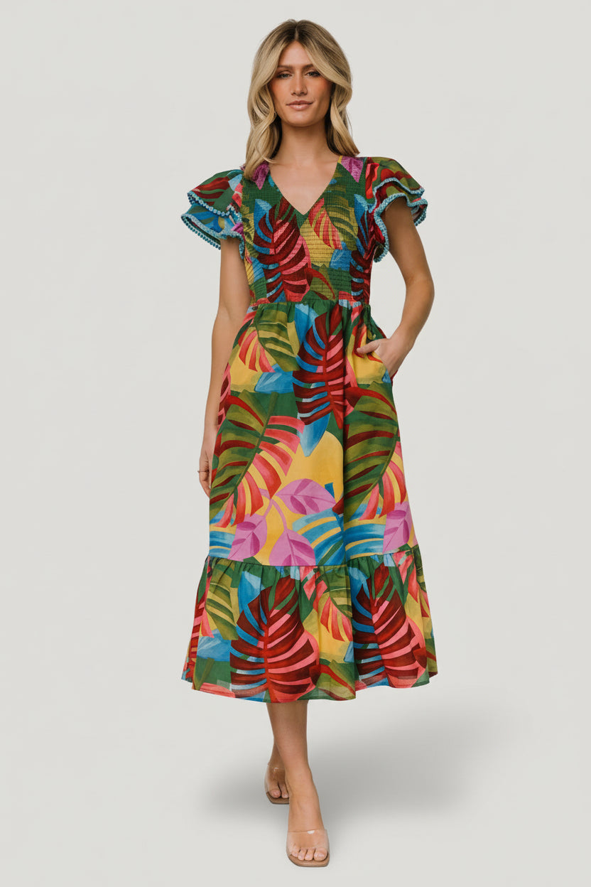 Three-quarter view of Marielle smocked midi dress in multicolor leaf print; shows smocked bodice, elastic waist, and midi silhouette.
