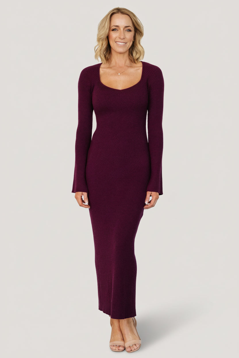 Marika Ribbed Midi Dress in deep merlot wine shown on model, fitted silhouette with deep V-neck and center-back slit, long raglan sleeves.
