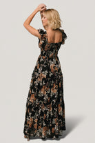 Close-up of the Black + Copper Floral print and fabric texture on the Martina Maxi Dress, showing chiffon drape and muted copper tones.