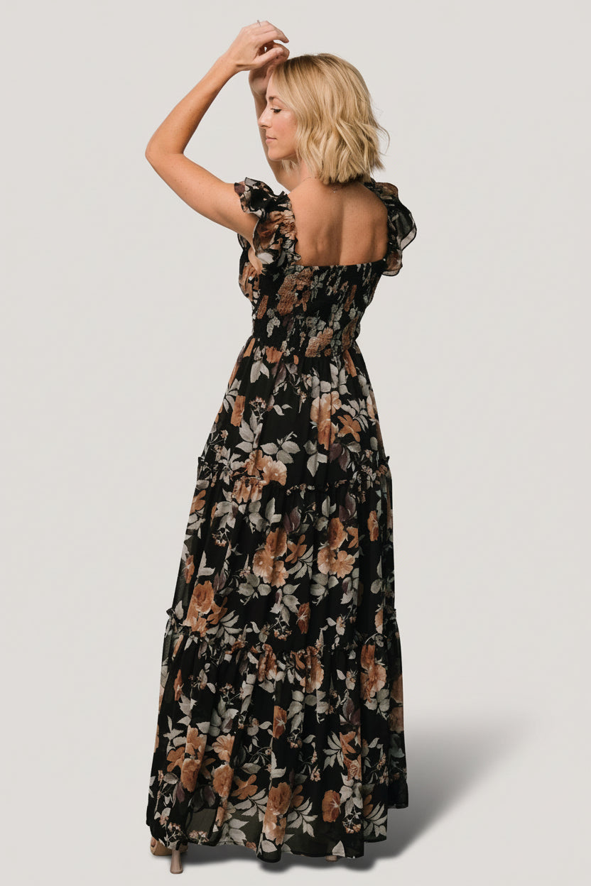 Close-up of the Black + Copper Floral print and fabric texture on the Martina Maxi Dress, showing chiffon drape and muted copper tones.