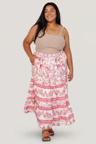 Close-up of Meg skirt fabric and print showing soft rayon drape, blush and pink floral details, and textured tier seams for movement.