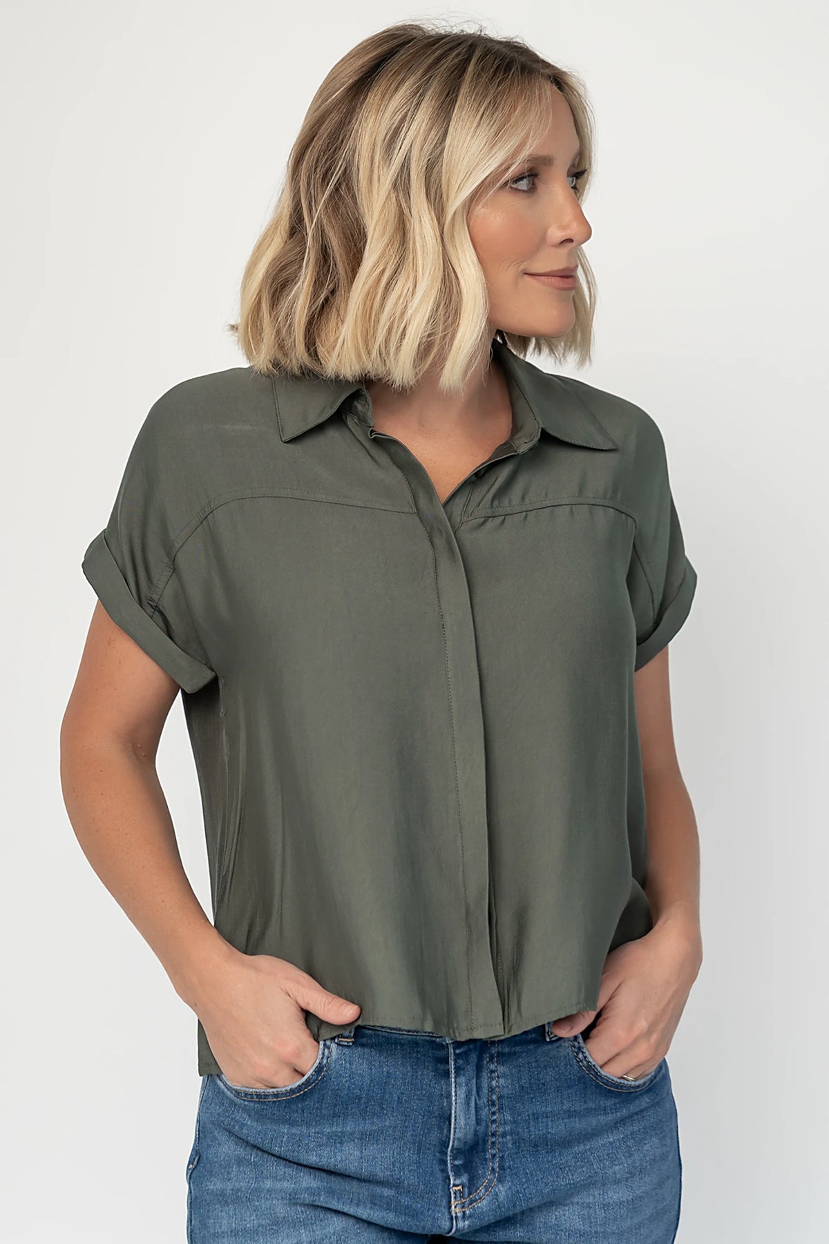 Miriam Top in Dark Sage with collared neckline, concealed button front, cuffed short sleeves, and relaxed silhouette.