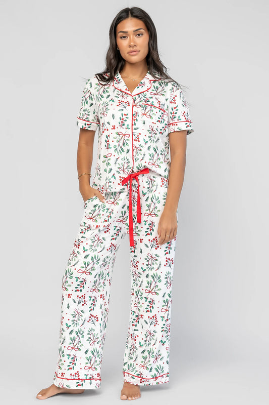 Mistletoe Cozy Pajama Set in Ivory Multi with a festive mistletoe and holly print, button-front top, and contrast piping.