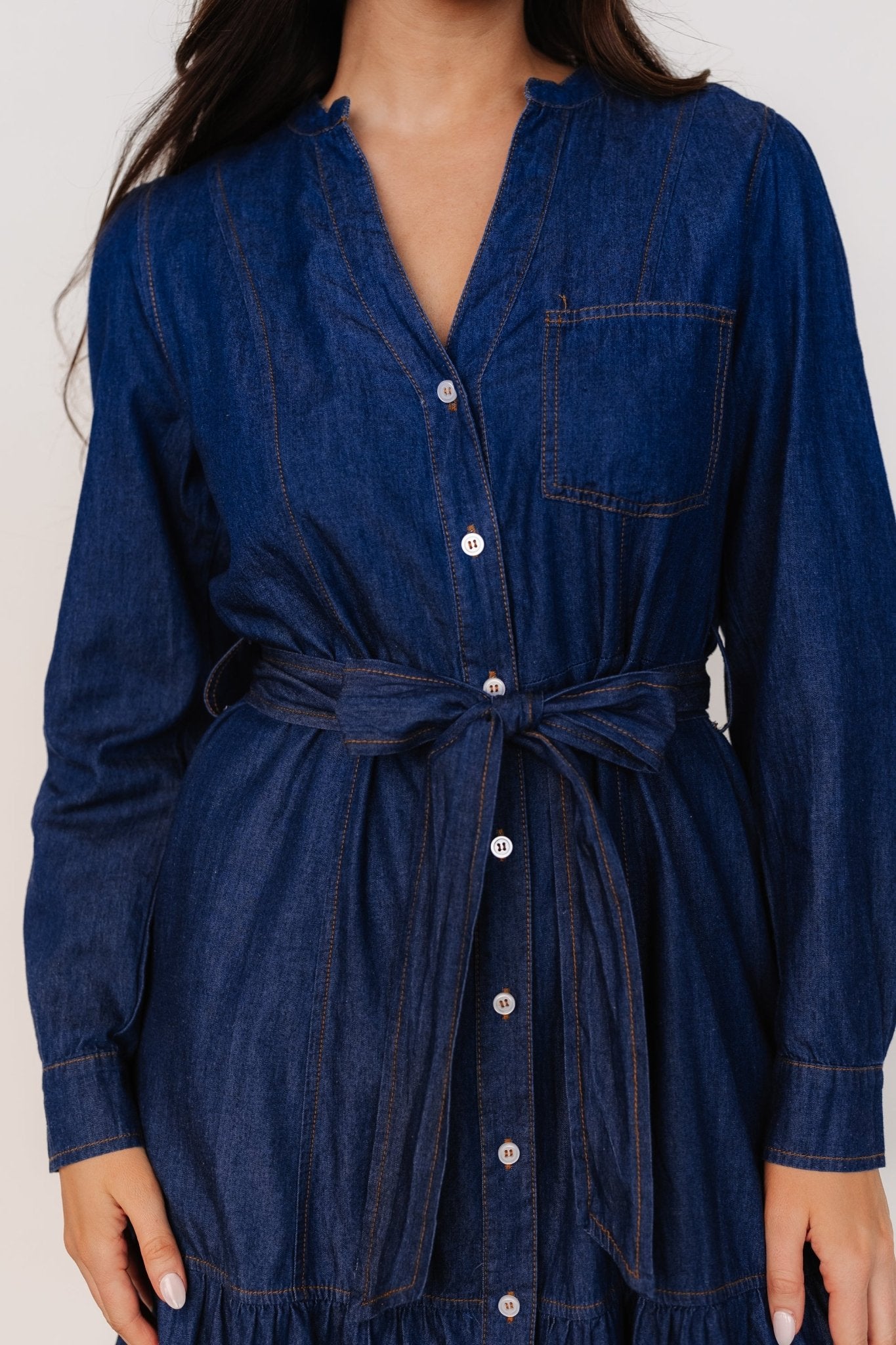 Back and side detail of Misty Midi Dress in denim blue, highlighting tiered skirt and functional side pockets.