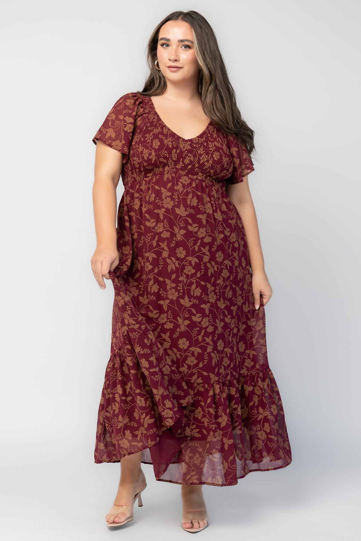 Monica Smocked Dress in Wine + Gold with V-neckline, smocked bodice, flutter sleeves, high waist, and tiered skirt.