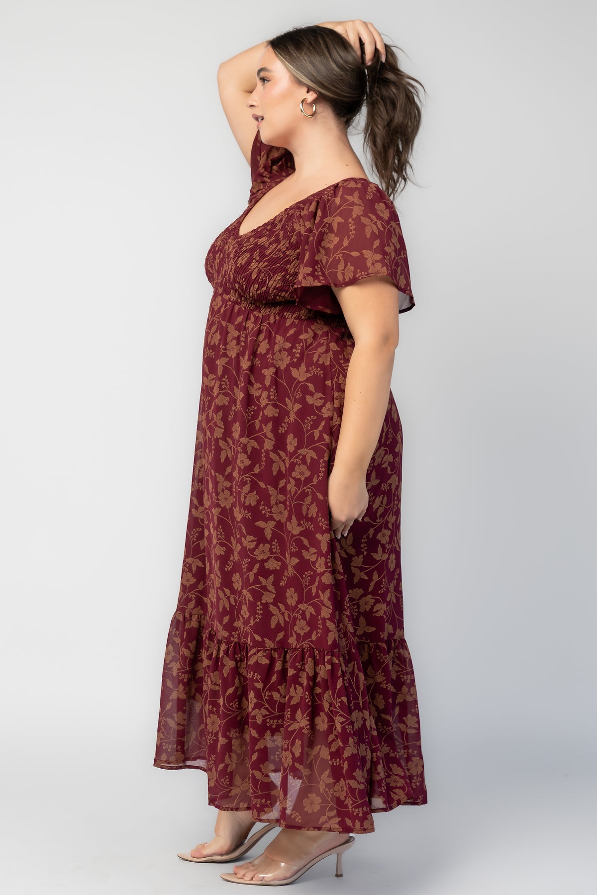 Monica Smocked Dress in Wine + Gold with V-neckline, smocked bodice, flutter sleeves, high waist, and tiered skirt.