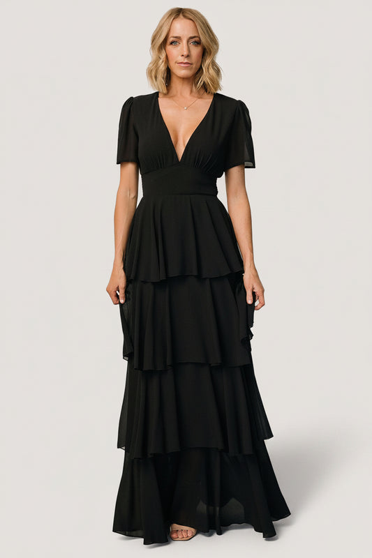 Three-quarter view of the black Montaigne maxi dress highlighting the contouring under-bust panel and flowing chiffon skirt with tiered ruffles.