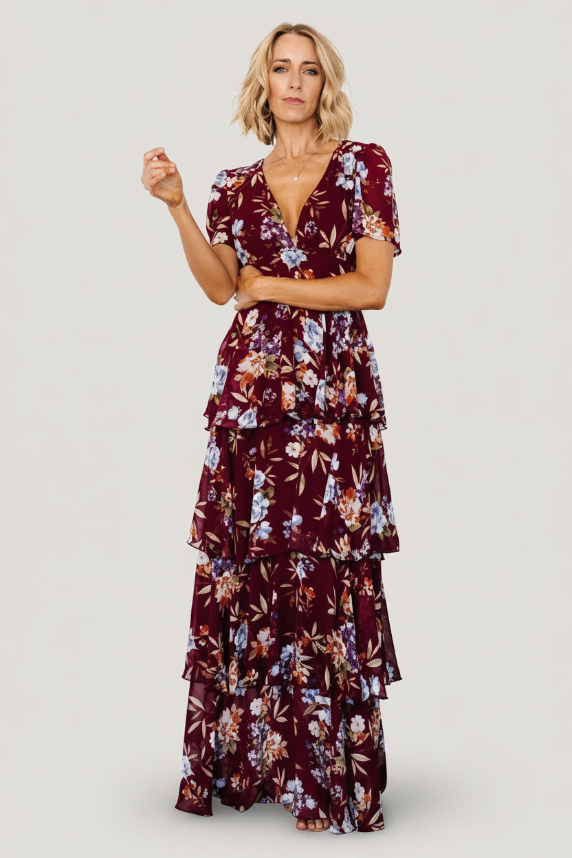 Back view showing smocked back and full lining of the mulberry floral maxi dress, with ruffle tiers visible along the skirt.