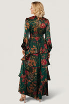 Back view of emerald floral maxi dress showing smocked back panel and how the fabric gathers at the waist for a comfortable fit.