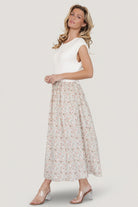 Side view of Myra dress highlighting natural elastic waistline and soft drape of the lined floral skirt.