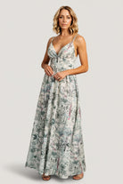 Styled look of Naia Maxi Dress on model walking, illustrating the flowy maxi skirt, gathered bust, and flattering high-waist silhouette.
