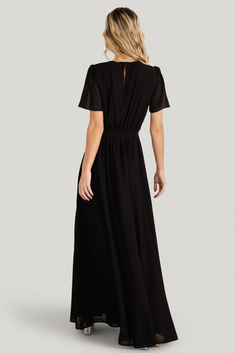 Detail view of removable waist tie knotted at natural waist, illustrating adjustable fit and feminine shaping.