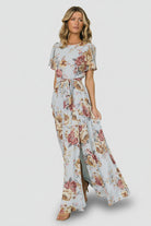 Back view of Naomi short-sleeve maxi dress displaying keyhole-and-button closure, elastic back waist, and detachable belt.