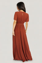 Back view of Naomi cinnamon chiffon maxi dress showing keyhole with button closure and elastic back waist detail.